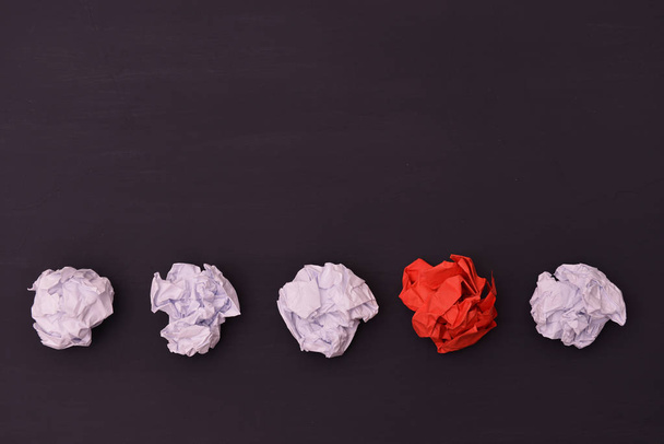Crumpled white and red paper on a black background. - Photo, Image