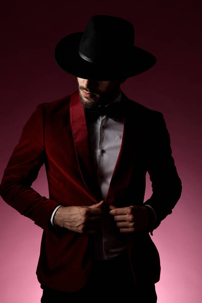 young fashion model wearing red velvet tuxedo and hat - Фото, изображение