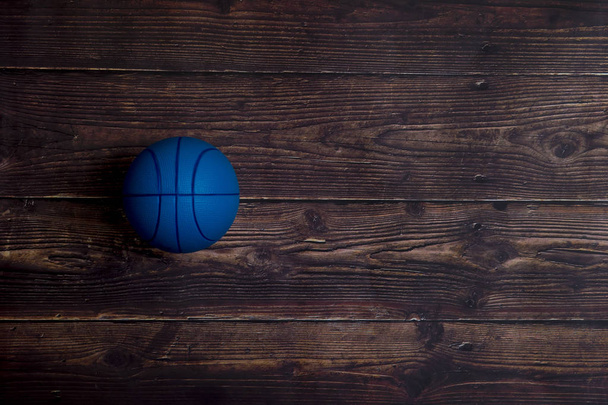 Blue Basketball On old Hardwood Court Floor With Spot Lighting - Photo, Image