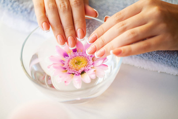 Nails care. Beautiful womans nails with french manicure, in beauty studio - Valokuva, kuva