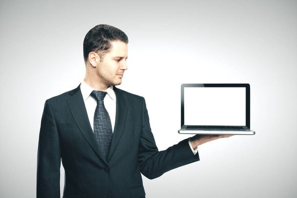businessman in suit holding laptop - Fotó, kép