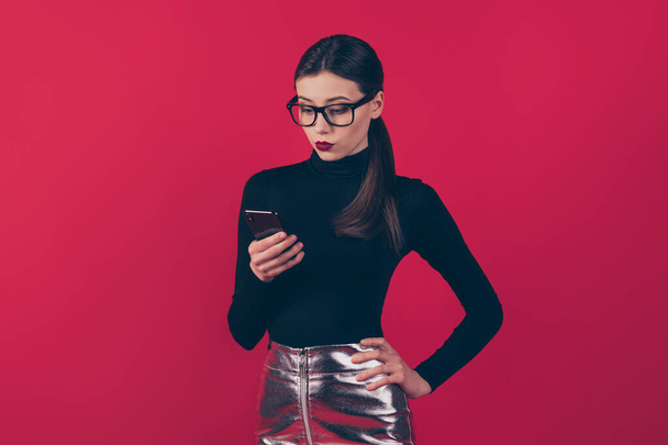 Portrait of her she nice-looking attractive trendy pretty fashionable focused serious girl using cell business app 5g isolated on maroon burgundy marsala red pastel color background - Photo, image