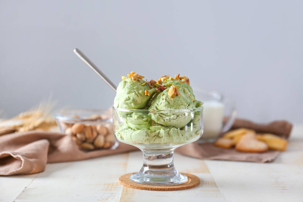 Bowl with tasty pistachio ice cream on table - Valokuva, kuva