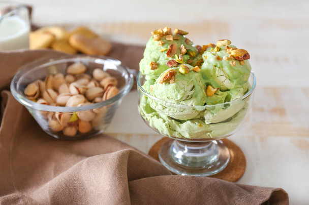 Bowl with tasty pistachio ice cream on table - Zdjęcie, obraz