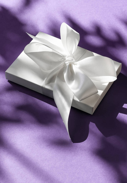 Luxe vakantie witte gift box met satijnen lint en strik op Violet - Foto, afbeelding