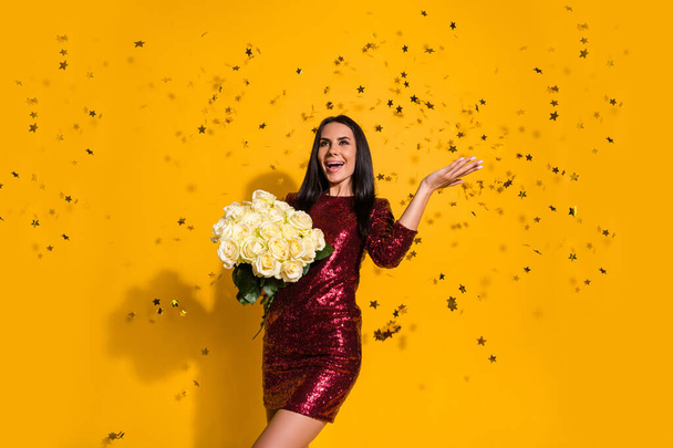 Portrait of her she nice-looking attractive charming lovely gorgeous cheerful cheery girl holding in hands roses enjoying fest isolated on bright vivid shine vibrant yellow color background - Fotoğraf, Görsel