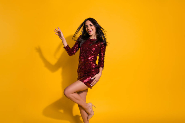Dancing queen. Profile photo of amazing lady with perfect slim shapes dancing like celebrity wear short shine red dress isolated yellow color background - Valokuva, kuva