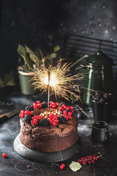Fire Chocolate Cake with Berries, new year concept - Fotó, kép