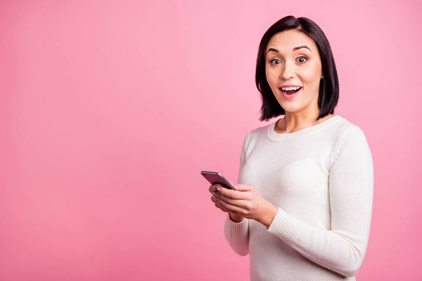 Profile photo of amazing lady holding telephone reading positive comments on new post wear white pullover isolated pink color background - Φωτογραφία, εικόνα