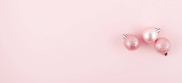 pink christmas balls on pink paper background - Fotoğraf, Görsel