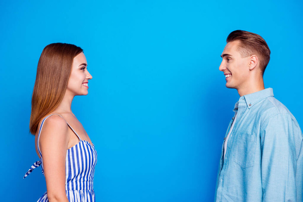 Profile side view portrait of her she his he two nice attractive charming lovely content cheerful cheery people looking at each other isolated over bright vivid shine vibrant blue color background - Fotoğraf, Görsel