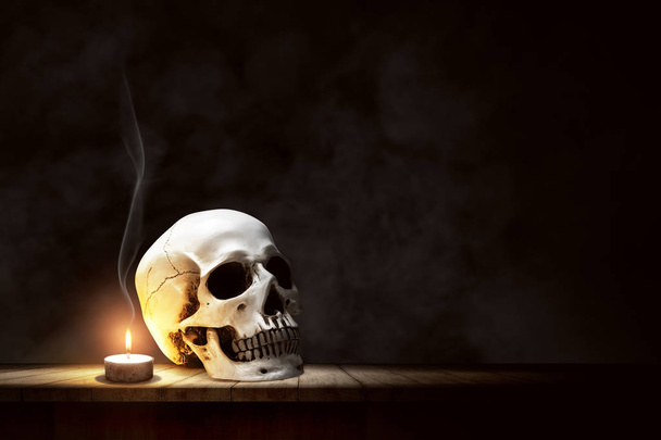 Candle and human skull on wooden table - Foto, immagini