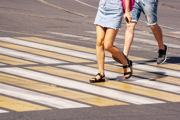 legs of young pedestrians walking on the crosswalkl - Photo, Image