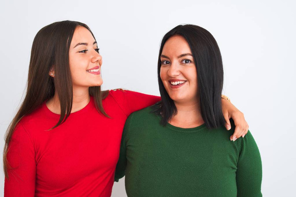 Young beautiful friends smiling happy and confident wearing casual clothes. Standing with a smile on face hugging over isolated white background - Φωτογραφία, εικόνα