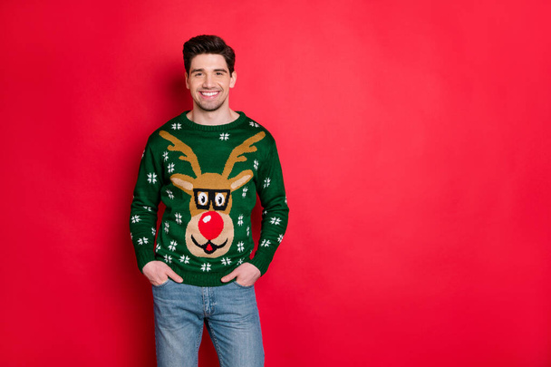 Portrait of handsome content man wear deer reindeer sweater enjoy theme x-mas party isolated over red color background - Foto, afbeelding