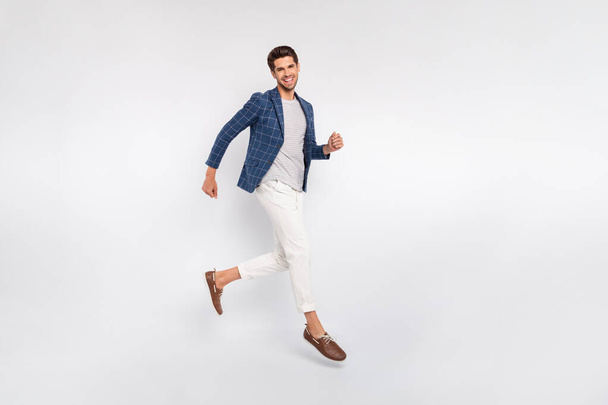 Full length body size view of his he nice attractive luxurious cheerful cheery director wearing checked blazer modern clothing jumping running motion isolated over light white pastel background - Foto, immagini