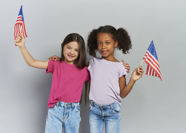 Two girls holding American flag - Photo, Image