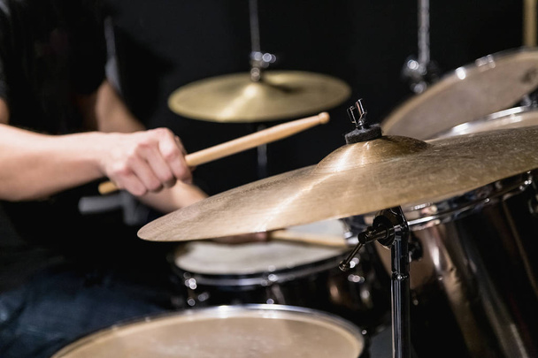 Close up of cymbal and man hand holding drumstick - Zdjęcie, obraz