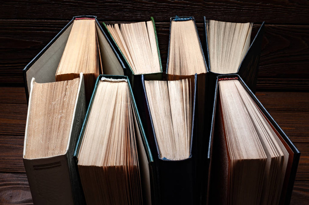 Régi könyvek. Régi használt nyitott könyvek csoportja a porban sötét háttérrel.  - Fotó, kép
