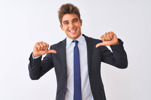 Young handsome businessman wearing suit standing over isolated white background looking confident with smile on face, pointing oneself with fingers proud and happy. - Photo, Image
