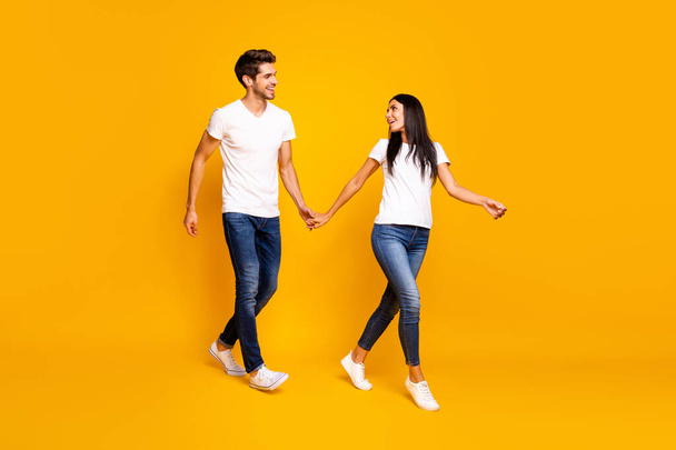 Come with me honey. Full body photo of two people walking down street for shopping wear casual clothes isolated yellow color background - Φωτογραφία, εικόνα