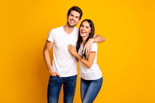 Photo of nice couple in love glad to see old friends talking different stuff wear casual clothes isolated yellow color background - Foto, Imagem