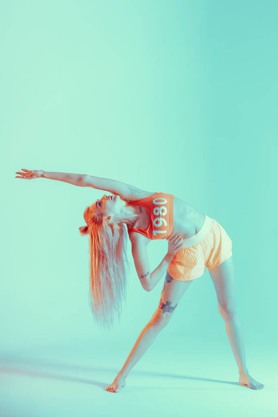 Athletic young woman doing yoga exercise - Photo, Image