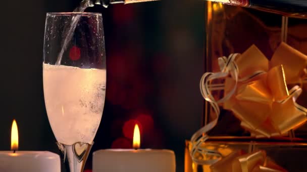 Pouring a glass of champagne with party lights - Video