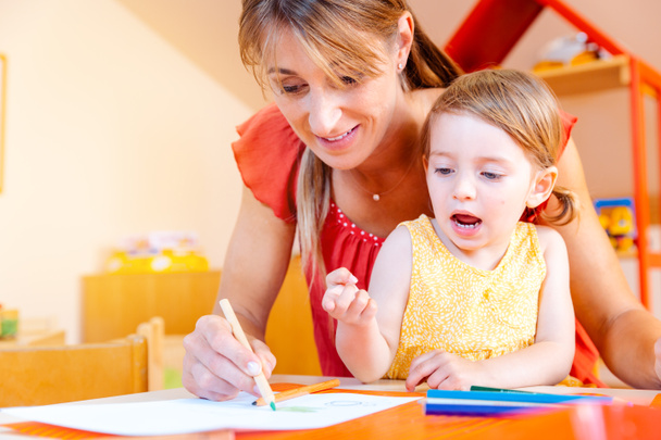 Children and play school teacher drawing together - Photo, Image