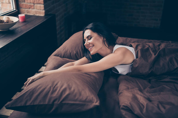 Portrait of her she nice attractive lovely lovable charming cute winsome pretty cheerful cheery girl lying in bed stretching industrial brick loft style interior room flat apartment house indoors - Fotoğraf, Görsel