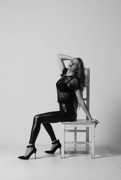 Stunning brunette beauty sitting on a chair - Fotografie, Obrázek