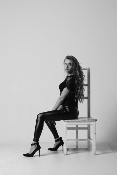 Stunning brunette beauty sitting on a chair - Fotoğraf, Görsel