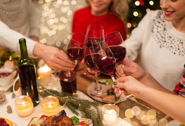 close up of friends with wine celebrate christmas - Photo, image