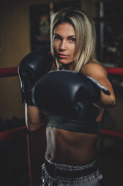 Portrait of experienced female boxer - Φωτογραφία, εικόνα