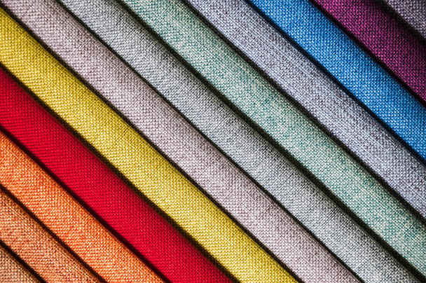 Colorful and bright fabric samples of furniture and clothing upholstery. Close-up of a palette of textile abstract diagonal stripes of different colors - Foto, Imagen