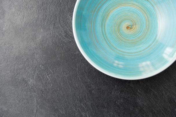 close up of blue ceramic plate on slate background - Foto, Imagen