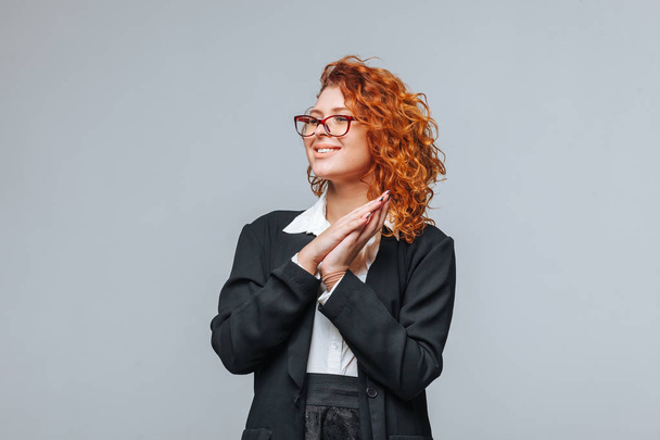 Red-haired woman in a black jacket and glasses smiling - Photo, Image