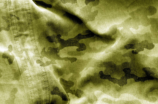 Dirty camouflage cloth with blur effect in yellow tone. - Photo, Image