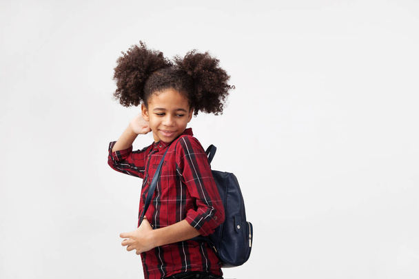 Cute smiley girl in chequered shirt with backpack - Foto, Imagen