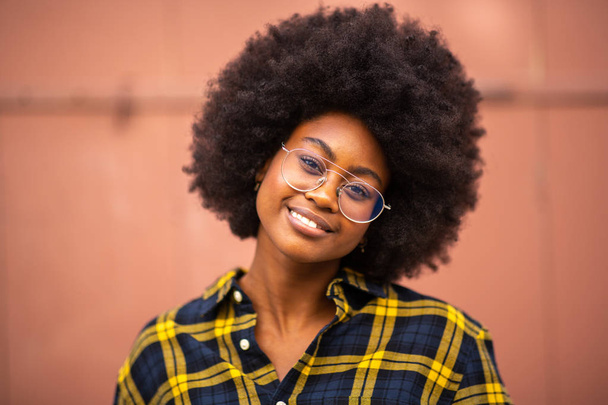 Close up front portrait of beautiful young african american woman with glasses - Фото, изображение