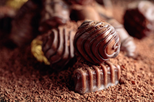 Czekoladowe cukierki posypane czekoladowymi chipsami. - Zdjęcie, obraz
