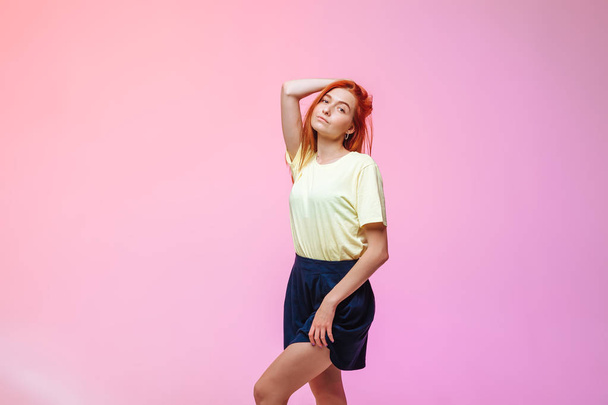 Redhead girl posing on pink background - Photo, Image