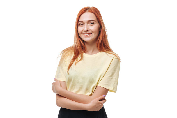 Redhead girl crosses her arms and smiles on white isolate backgr - Photo, Image