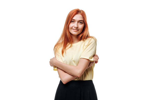 Redhead girl crosses her arms and smiles on white isolate backgr - Photo, Image