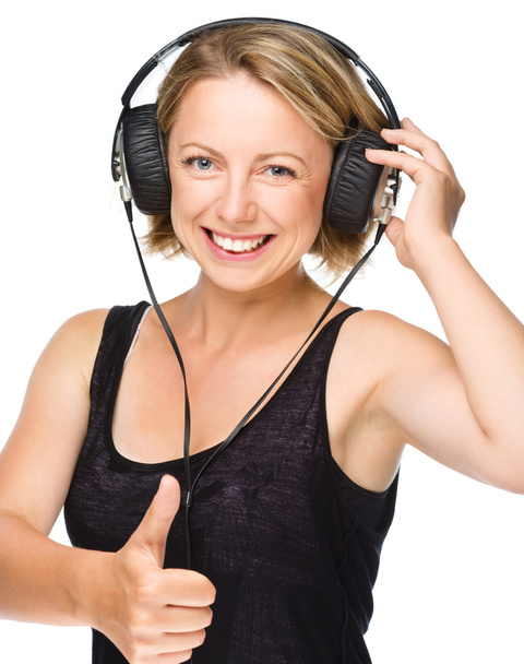Young woman enjoying music using headphones - Zdjęcie, obraz