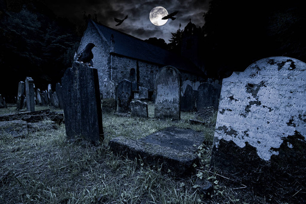 old graveyard with ancient tombstones grave stone and old church - Photo, Image