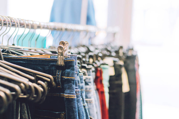 Colorful trend women dresses, pants  on hangers in retail shop,  - Fotoğraf, Görsel