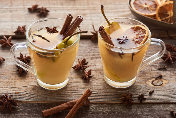 seasonal traditional pear mulled wine with spices in glasses on wooden rustic table - Photo, Image
