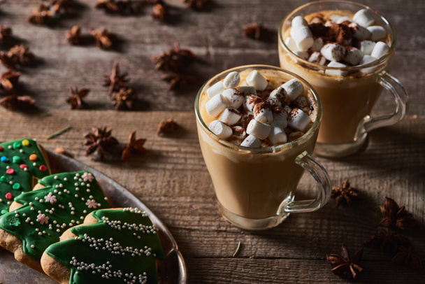 cacao with marshmallow on wooden table with anise and Christmas cookies - Foto, imagen