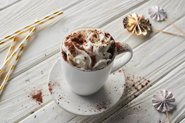 Christmas cacao with cacao powder and whipped cream on white wooden table with decoration - Photo, Image